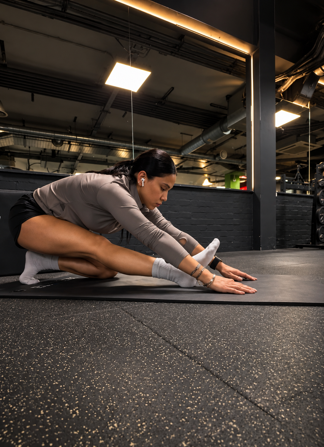 Irem stretching on a mat at Energie Fitness Old Street