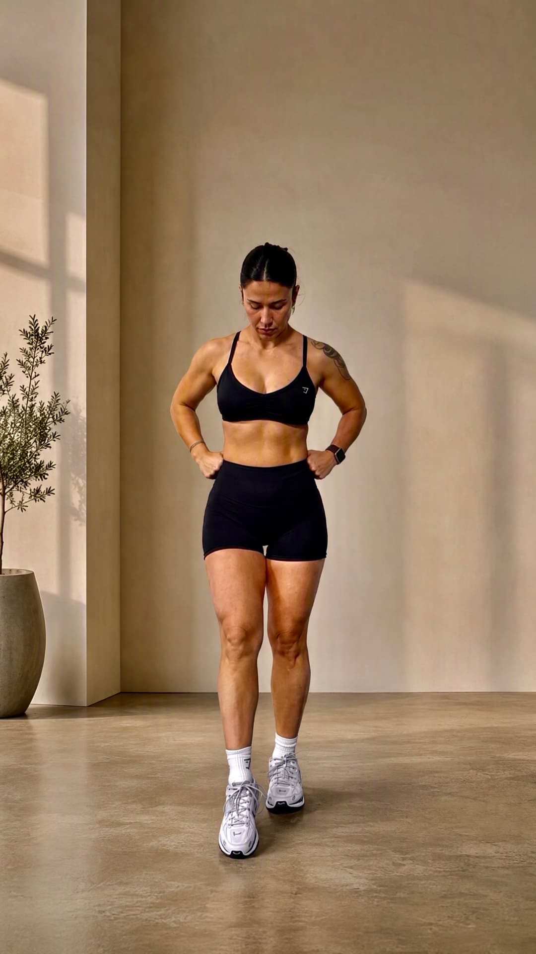 Irem, personal trainer, in a warm beige studio